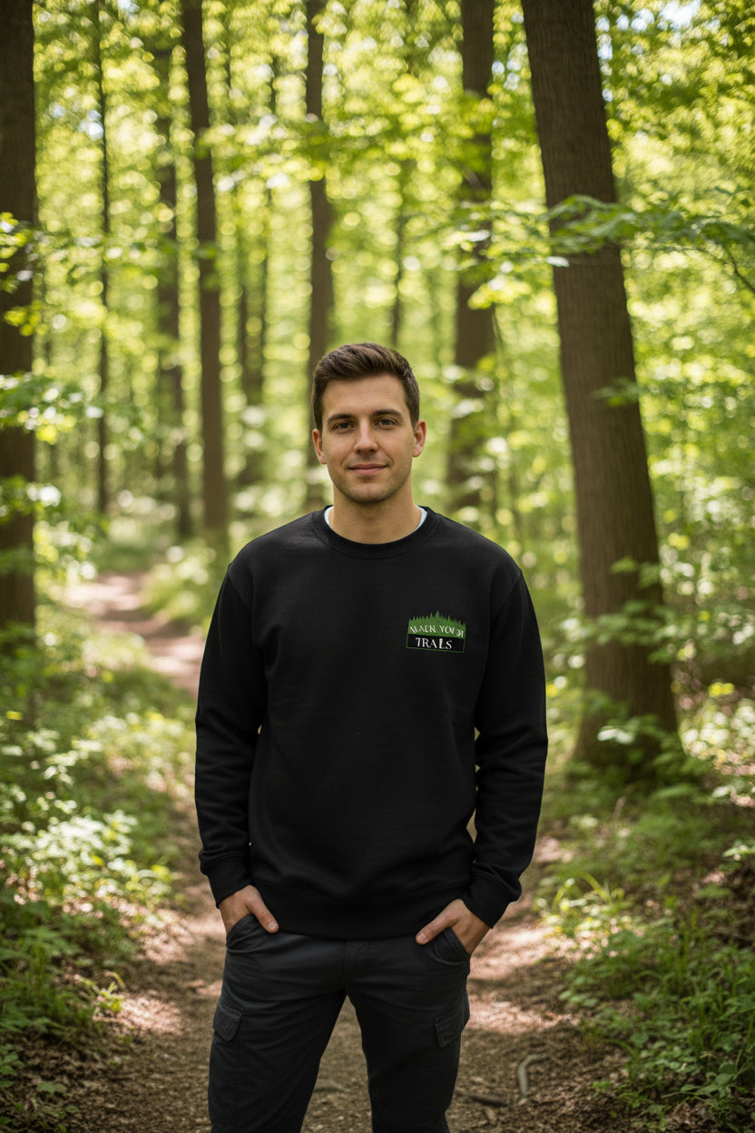 Unisex Premium Sweatshirt, Man wearing a black sweatshirt with a logo in a forest