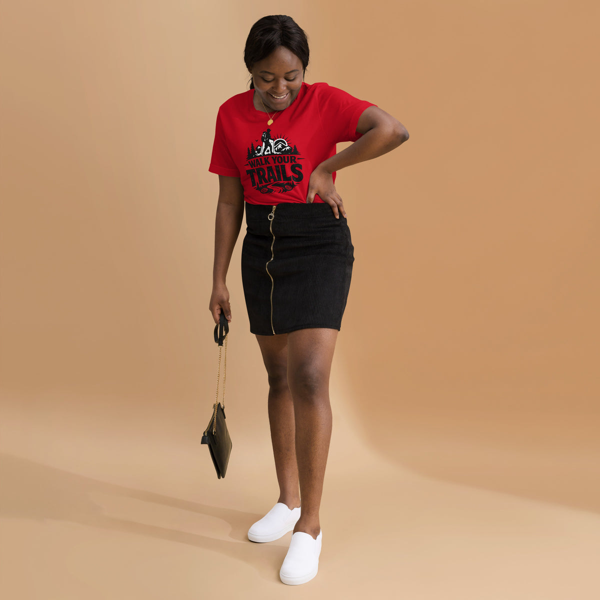 Unisex T-Shirt, Woman wearing a red t-shirt and black skirt on a beige background