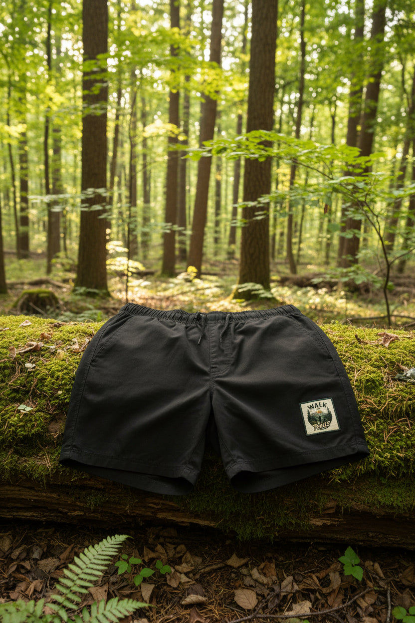 Walk Your Trails outdoor gym shorts displayed on a forest floor, highlighting their rugged, nature‑inspired design and suitability for hiking, walking, and everyday outdoor movement.