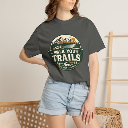 Unisex Garment Dyed T-Shirt, Person wearing a dark gray t-shirt with a graphic design, standing against a neutral background.