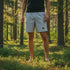 'Walk Trails' Outdoor Gym Shorts: Light gray athletic shorts with a black outline, featuring a small 'WALK TRAILS' graphic patch on the lower left leg.