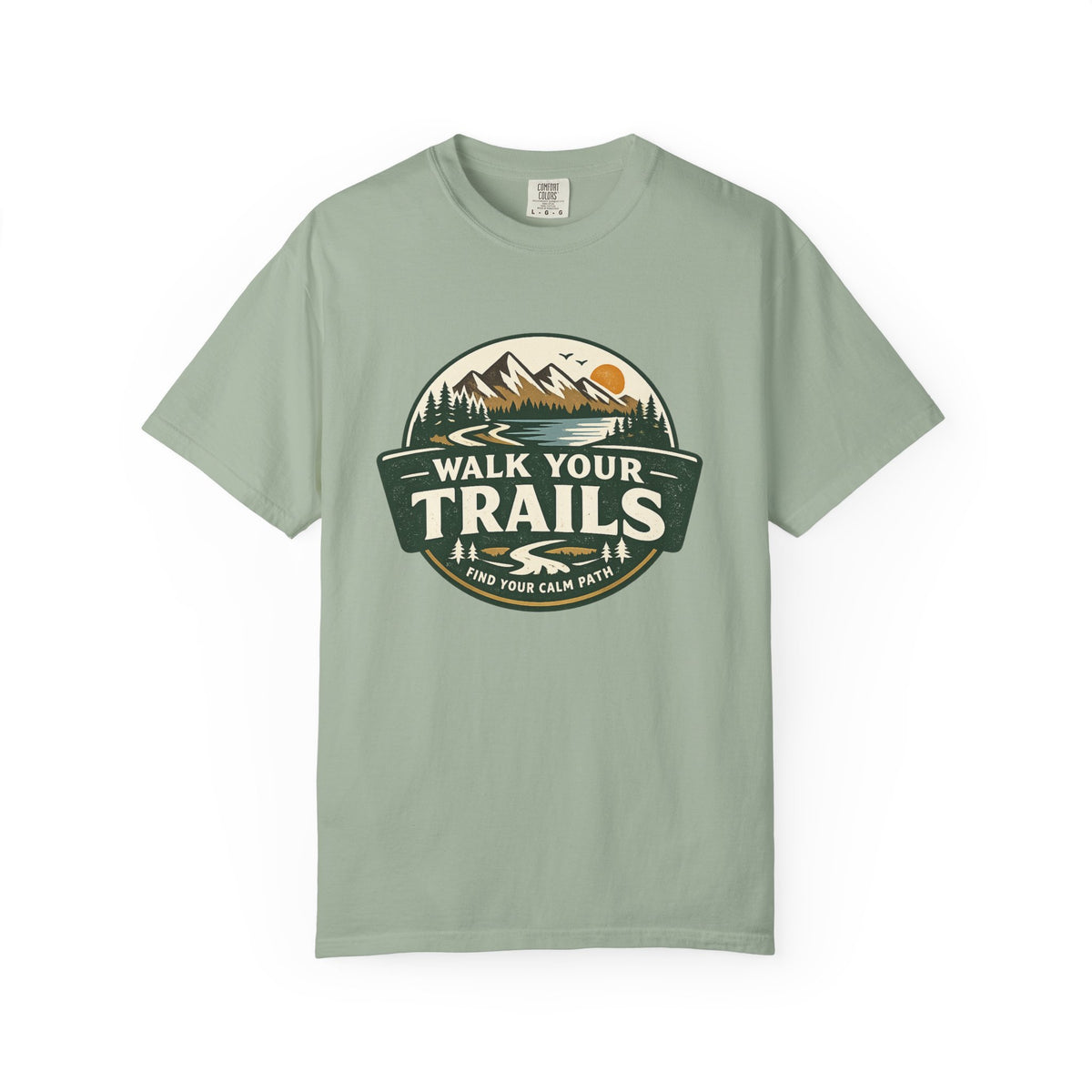 Unisex Garment Dyed T-Shirt, “Light green T‑shirt with circular mountain‑and‑sun graphic and ‘Walk Your Trails – Find Your Calm Path’ text on white background.”