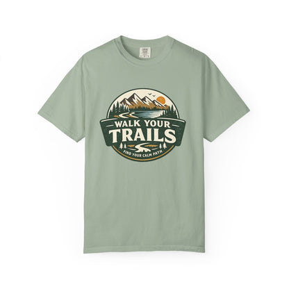 Unisex Garment Dyed T-Shirt, “Light green T‑shirt with circular mountain‑and‑sun graphic and ‘Walk Your Trails – Find Your Calm Path’ text on white background.”