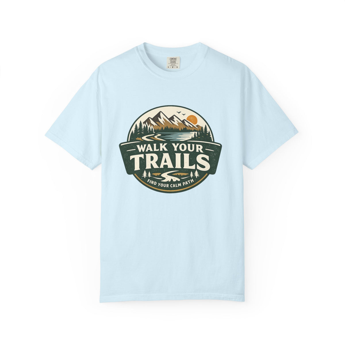 Unisex Garment Dyed T-Shirt, Light green T‑shirt with circular mountain‑and‑sun graphic and ‘Walk Your Trails – Find Your Calm Path’ text on white background.