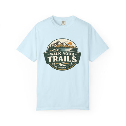 Unisex Garment Dyed T-Shirt, Light green T‑shirt with circular mountain‑and‑sun graphic and ‘Walk Your Trails – Find Your Calm Path’ text on white background.