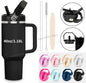 Black travel mug with handle, lid, straw, and cleaning brush on a white background.