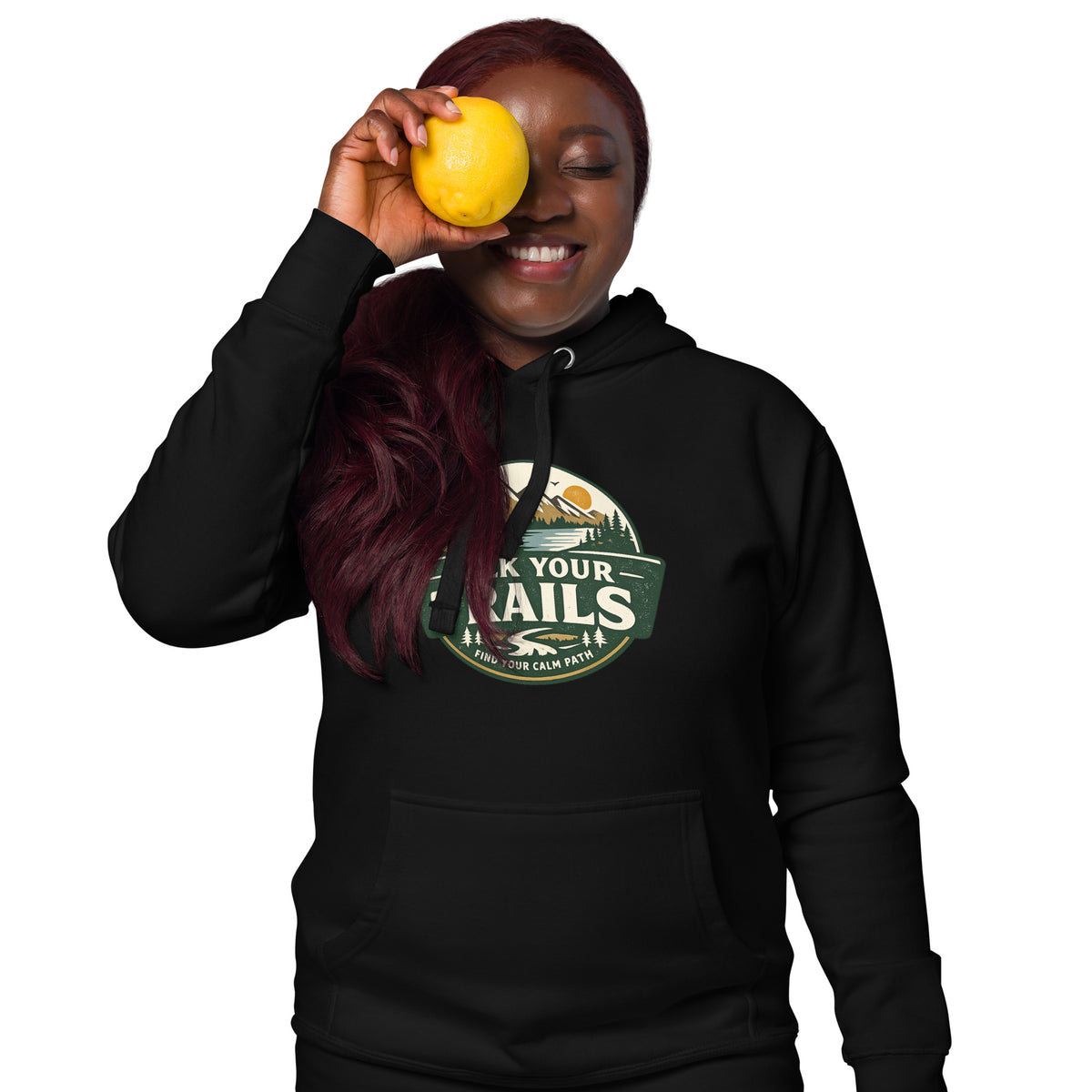 Unisex Hoodie Soft Warm Classic Fit, Person wearing a black hoodie with a colorful logo, holding a yellow fruit.